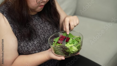 Asian Overweight woman dieting Weight loss eating fresh fresh homemade salad healthy eating concept Obese Woman with weight diet lifestyle.