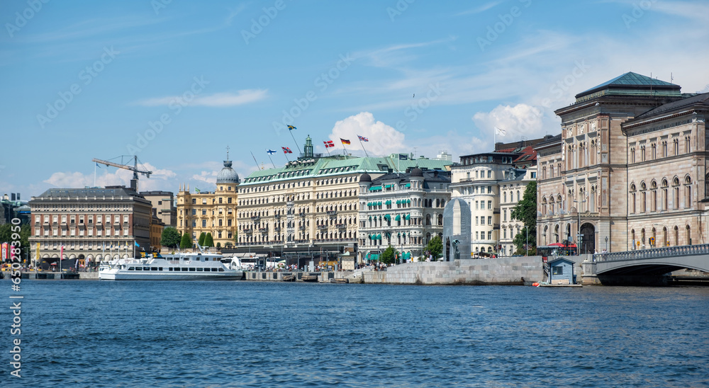 Stockholm, Sweden. Waterfront building at Strandvagen embankment in Ostermalm district. Moored boat
