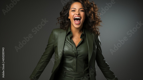 A businesswoman celebrates with a victory pose. Success business concept, copyspace.