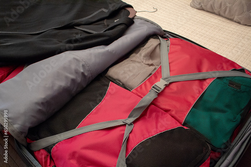 View of clothes in packing bags inside a suitcase.