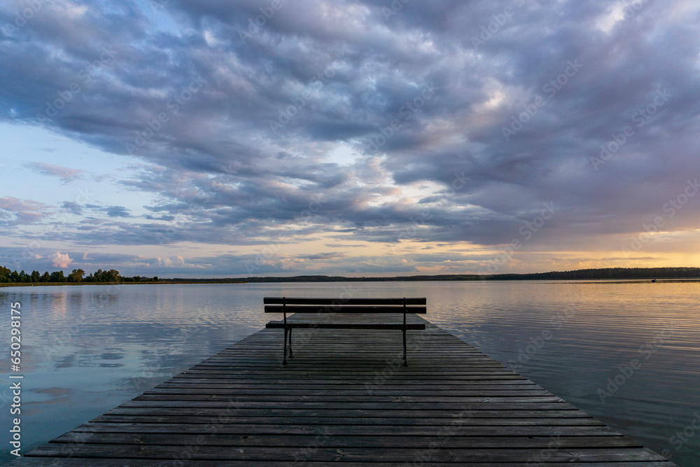 Wooden pier against the background of the lake and clouds. Wooden pier against the background of the lake and clouds.