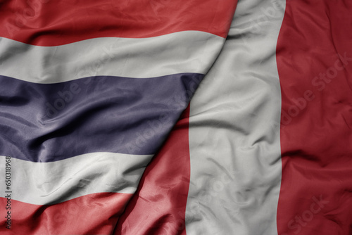 big waving national colorful flag of thailand and national flag of paraguay .