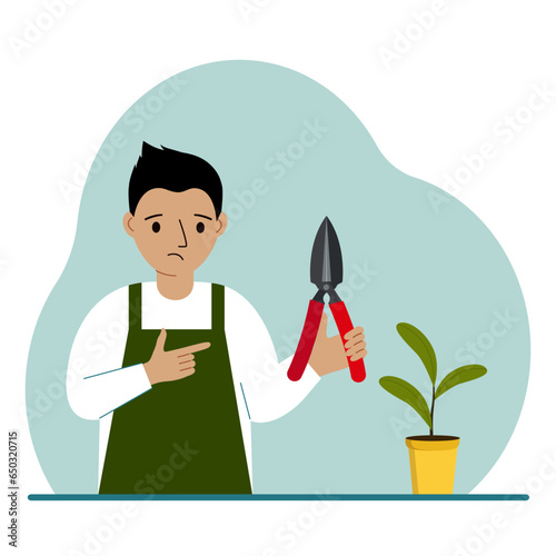 A gardener is a boy in working clothes, he has a pruner in his hand.