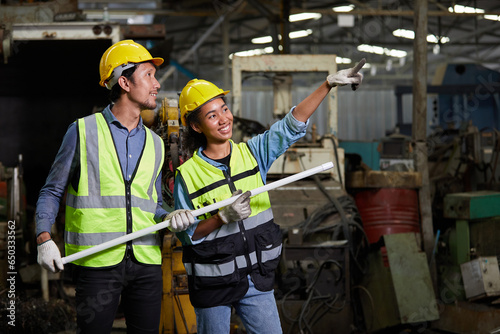 workers or engineers holding fluorescent lamp and pointing pose in the factory photo