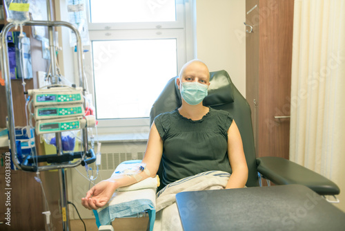 Young woman in hospital bed suffering from breast cancer receiving treatment photo