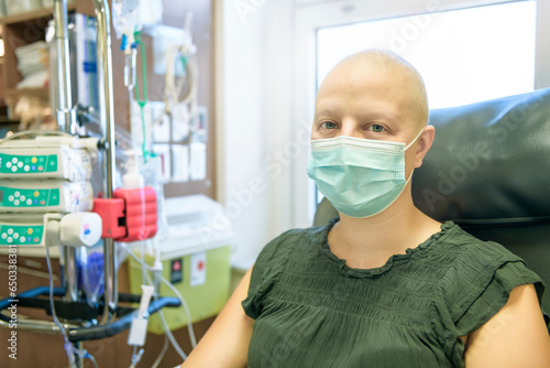 Young woman in hospital bed suffering from breast cancer receiving treatment photo