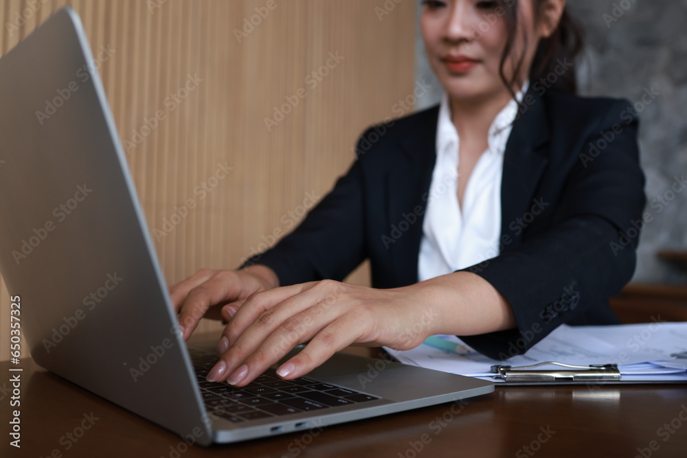 Enjoy Smart businesswoman working with a laptop in a working space Enjoy Smart businesswoman working with a laptop in a working space