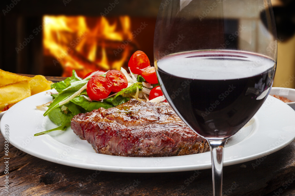 Roast steak with salad, glass of red wine Roast steak with salad, glass of red wine