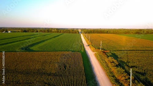 Aerial Descend Shot Of An Off-Road Vehicle On Road In Farm During Sunset, Drone Flying Over Landscape - Kansas City, Missouri