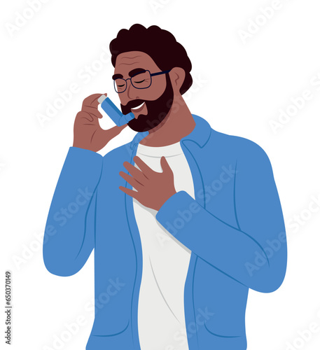 A smiling black elderly man uses an asthma inhaler against attack. World asthma day. Bronchial asthma. Allergy, asthmatic. Inhalation drug.