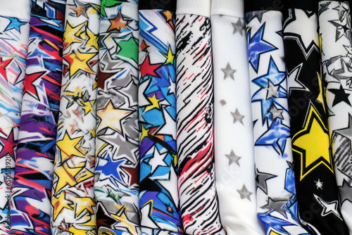 Billede på lærred A pair of socks with fun cartoon characters or prints laying on the bedroom floor, reflecting a youthful and playful fashion sense