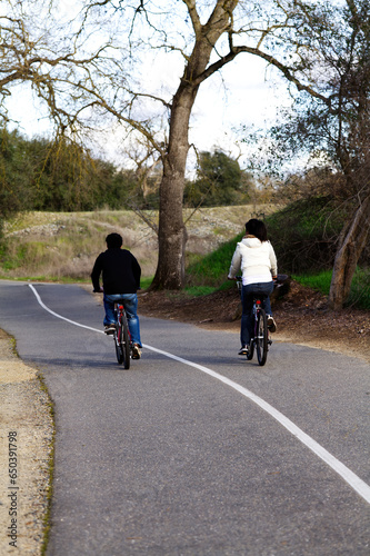 Man And Woman Riding Bikes On Trail California Winter