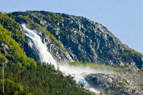 Majestic waterfall cascading down the rocky side of a mountainside