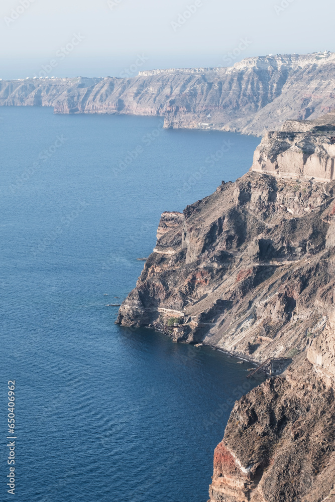 Cliff rocky landscape in the shore of the volcanic touristic island of Santorini, Mediterranean Sea, Greek Island