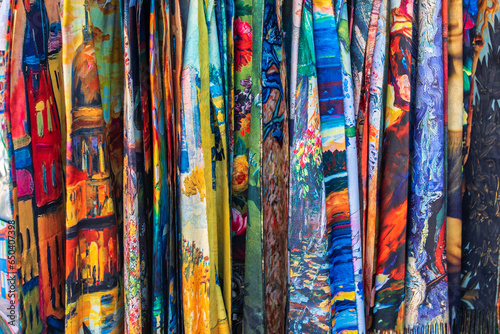 Bright multicolored fabric. Sale of scarves. Venetian, bright colors, abstract drawing.