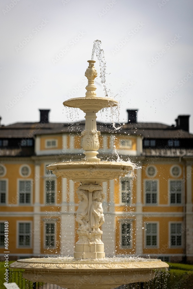 Picturesque fountain situated in front of the majestic Steningehojden Slottsby