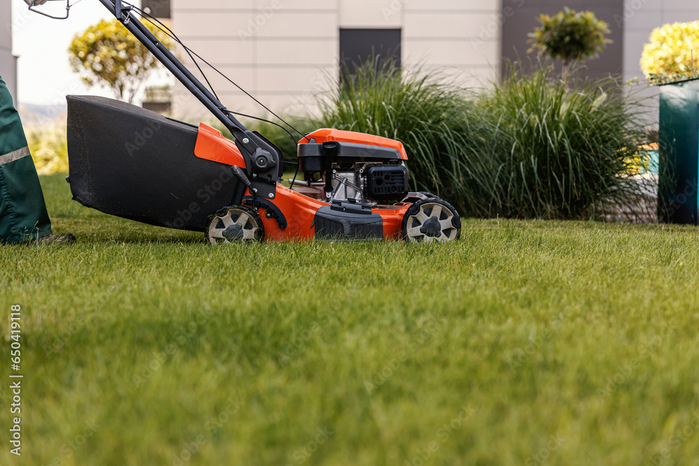 A lawn mower cutting grass in a public place.