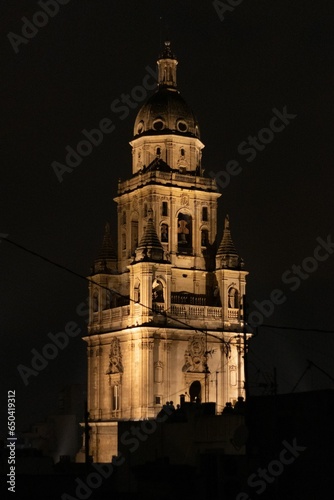 Stunning nighttime image of the Murcia Cathedral, illuminated by the lights of the city
