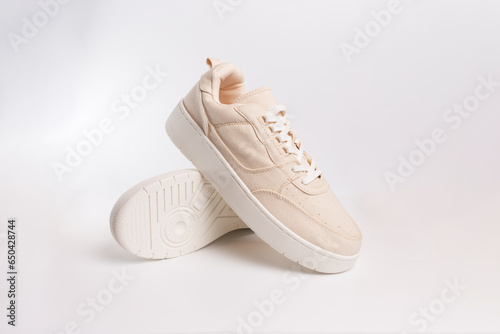 Wallpaper Mural Classic hipster biege sneakers on white background, active lifestyle. Summer concept. Torontodigital.ca