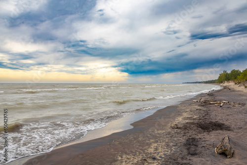 Dramatic clouds grace the skies at Long Point Provincial Park Beach on the shore of Lake Erie  Ontario.
