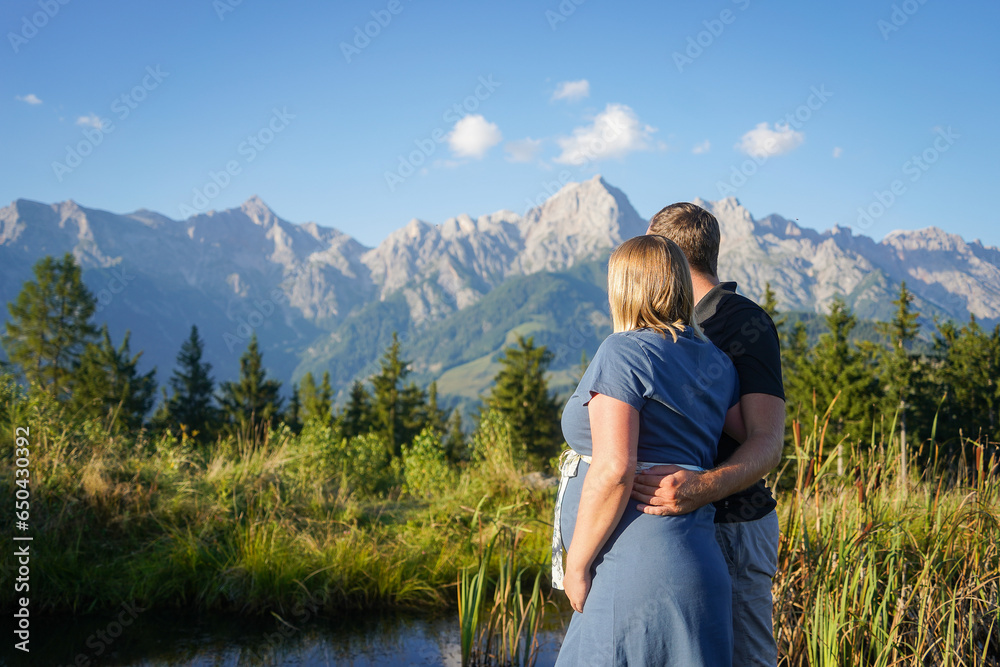 couple in the mountains enjoying the view over the mountain and a great landscape