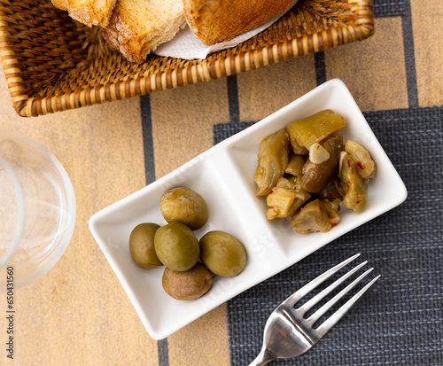 Appetizing pickled green olives and chopped eggplant marinated with garlic and spices. Typical mediterranean vegetable tapa ..