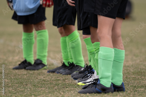 Boys soccer team of young legs wearing socks, shin guards, and cleats © motionshooter