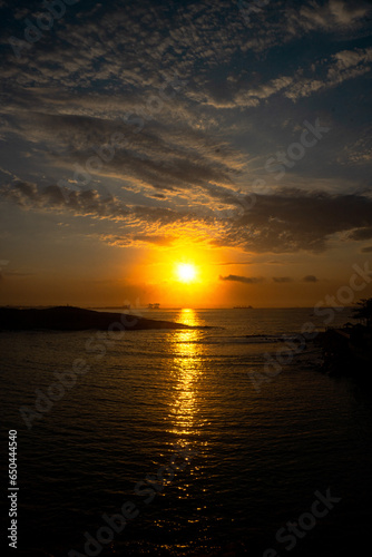 yellow sunset with reflection in the sea with the sky with clouds