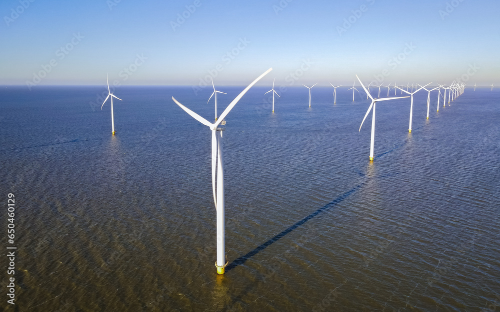 offshore windmill park with clouds and a blue sky, wind mill turbines in the Netherlands offshore windmill park with clouds and a blue sky, wind mill turbines in the Netherlands