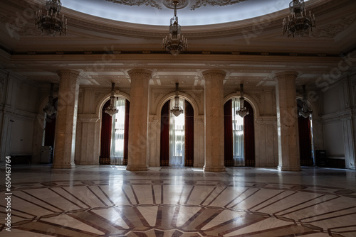 Selective blur on giant windows and opulent design of a hall in the interior of the Romanian palace of parliament in Bucharest, a symbol of romanian communism. photo