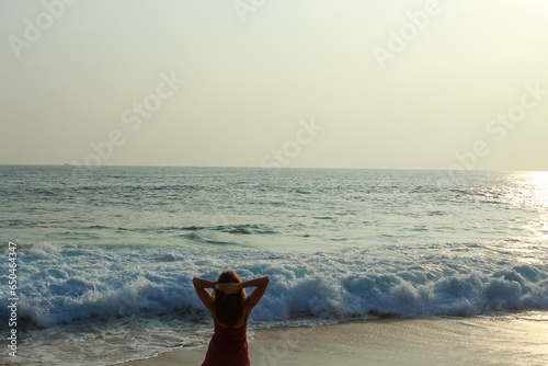 Silhouette of a woman enjoying the magical sunset at the beach of Unawatuna photo