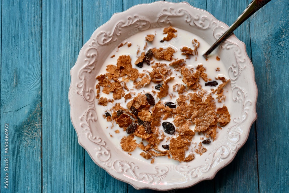 Top view of a bowl of Raisin Bran with milk Top view of a bowl of Raisin Bran with milk