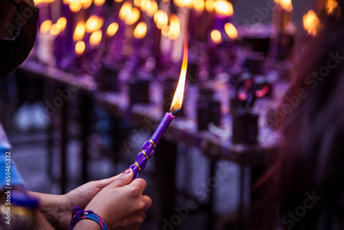 Hand of an unknown person holding a candle with his hand for the festival of the Lord of Miracles in Lima, Peru