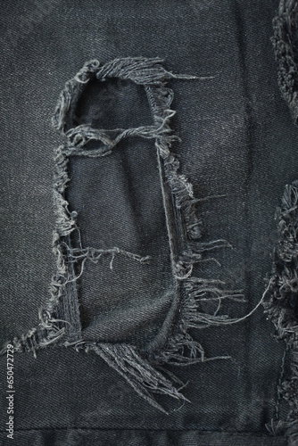 Valokuva torn black danim texture background, textile of jeans fashion for clothing desig
