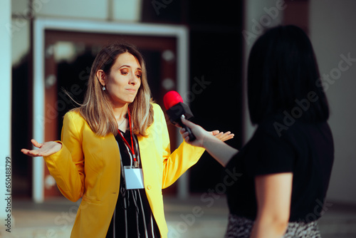 Woman Not Knowing What to Answer in a Street Interview. Reporter asking uncomfortable questions to a public relation specialist