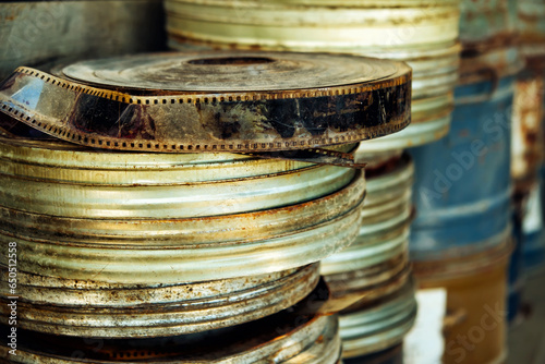 Retro boxes with film archived on the shelf. Close-up stack old movie film canisters, abandoned and rusty.