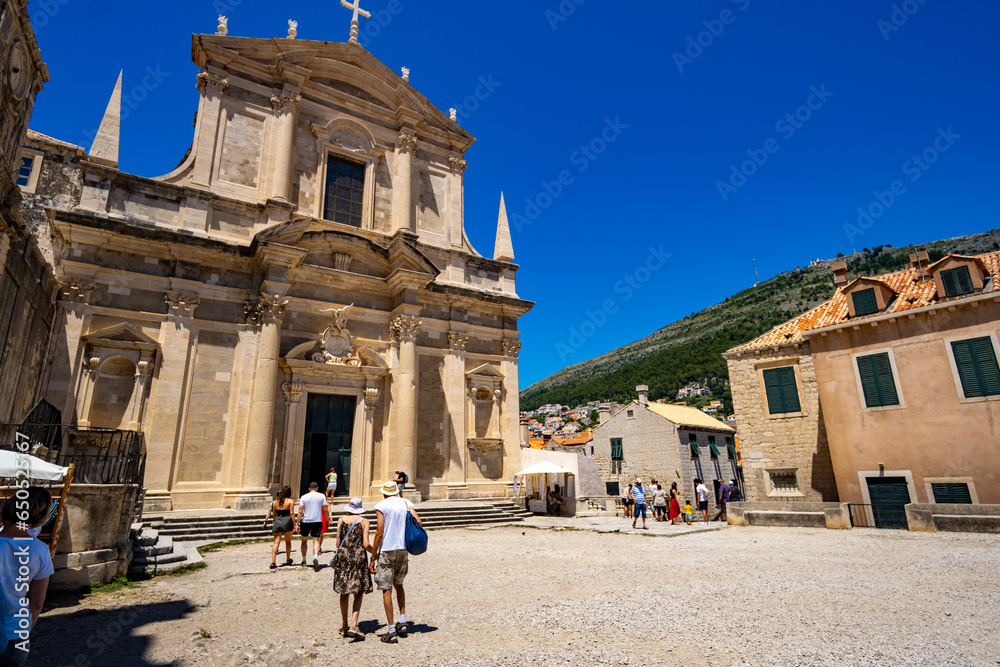 tourists travel through the historic city streets in Dubrovnik Old Town, Croatia, medieval European architecture