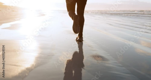 Fitness, sea or legs of runner on sand in cardio workout or exercise with speed training in Miami. Footwear, running or closeup of sports athlete sprinting or jogging at sunset in nature or beach photo