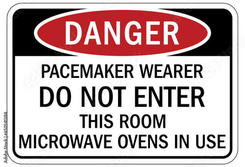 Magnetic field and pacemaker warning sign and labels Persons wearing pacemakers Do Not Enter. Microwave oven in use.