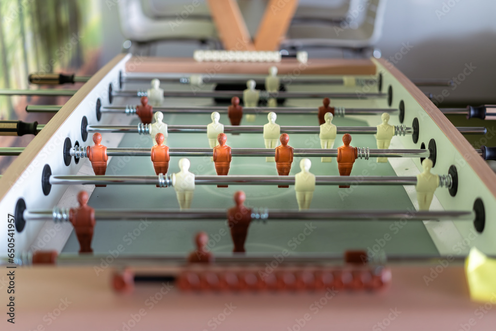 Obraz premium Foosball table. Office game. Game players. Play room interior.