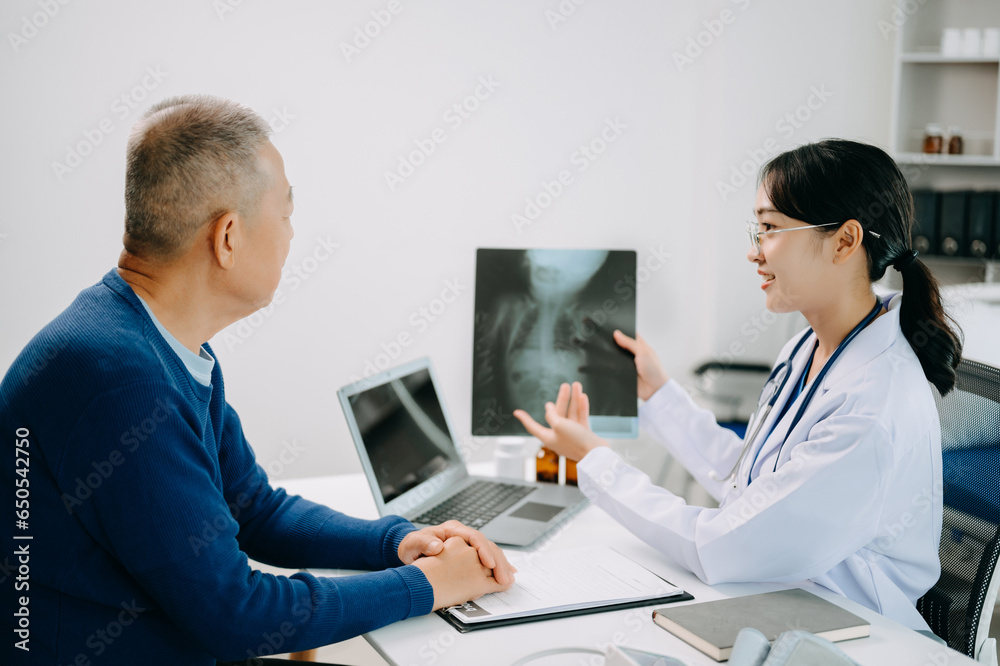 Serious Asia female doctor using clipboard is delivering great news talk discuss results or symptoms with female patient in clinic or hospital .