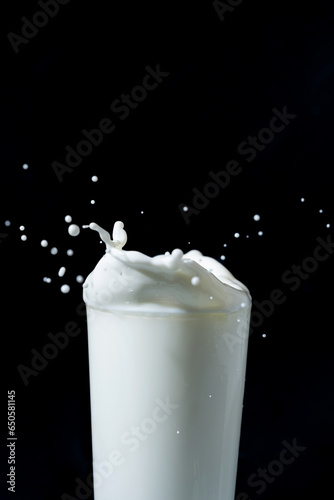 milk or white liquid splash isolated on black background 