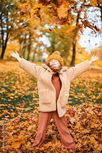 Little Child Baby Girl Caucasian Walking in Park with Leaf Autumn Nature Garden Leaves Golden Fall