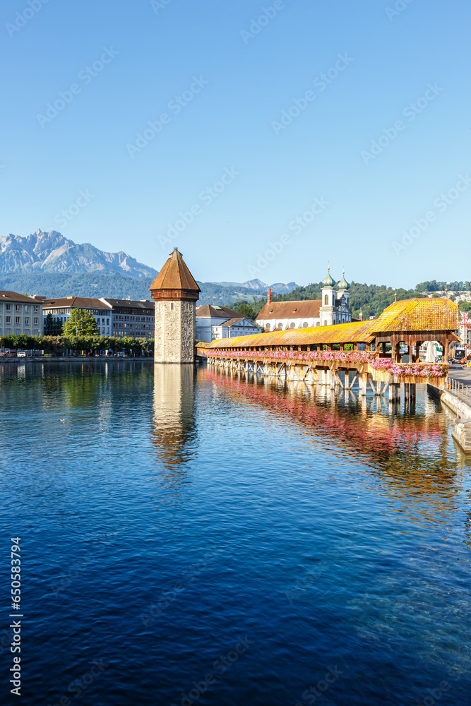 Lucerne city at Reuss river with Kapellbrücke and Pilatus mountain portrait format in Switzerland