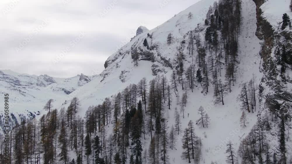 Reveal scenic cinematic aerial drone most famous snow cover mountain Matterhorn Zermatt Switzerland October November heavy fresh snowfall winter on climbing peak to the left circling movement Reveal scenic cinematic aerial drone most famous snow cover mountain Matterhorn Zermatt Switzerland October November heavy fresh snowfall winter on climbing peak to the left circling movement