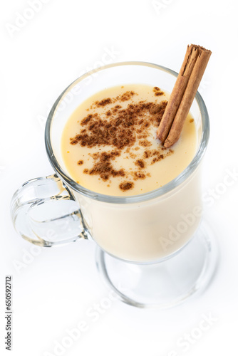Homemade eggnog with cinnamon on wooden table. Typical Christmas dessert