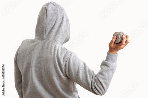 Fotografie Rear view of a man holding a stone to throw it with white background