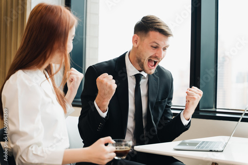 Happy business man looking at laptop screen, celebrating business success,happiness after a successful investment.