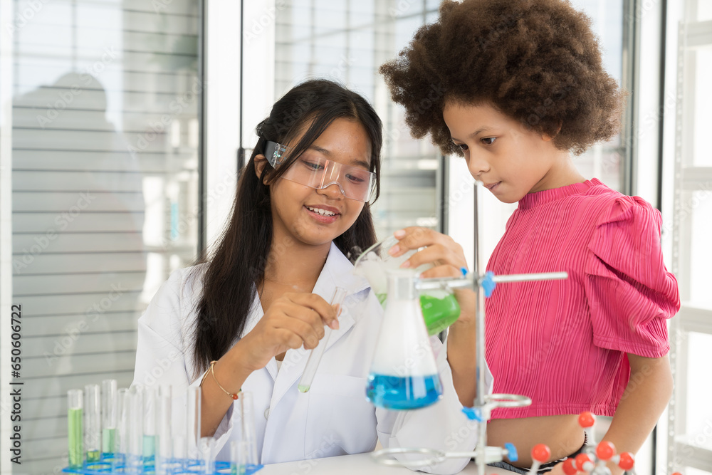 Asian children girl scientists learning science and doing analysis in the laboratory. Science and education, researcher and discovery concept Asian children girl scientists learning science and doing analysis in the laboratory. Science and education, researcher and discovery concept