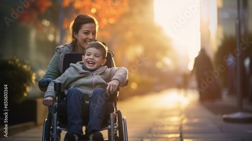 A beautiful little boy with a disability walks in a wheelchair with his mom at sunset. A child with disabilities photo